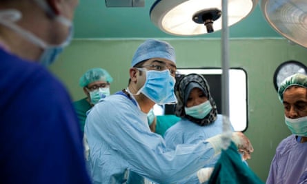 Dr Naveen Cavale, a specialist plastic reconstruction surgeon from King's College Hospital, London, performing an operation in al-Shifa Hospital, Gaza.
