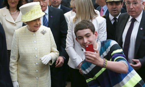 A teenager trying to take a selfie in front of the Queen in Belfast.