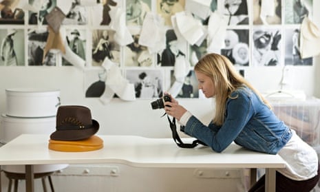 A woman designer photographing a hat