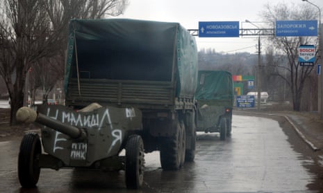 Ukrainian military trucks move cannons from their position in the eastern Ukrainian city of Mariupol.