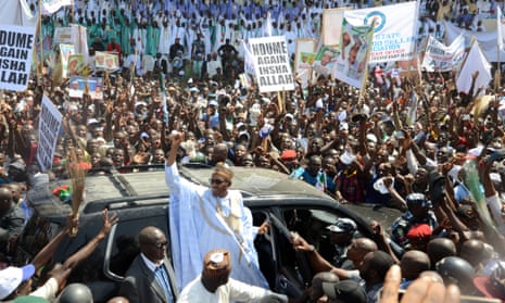 All Progressives Congress presidential candidate Muhammadu Buhari, centre, raises his hand during a campaign rally in the north-east city of Maiduguri earlier in February.