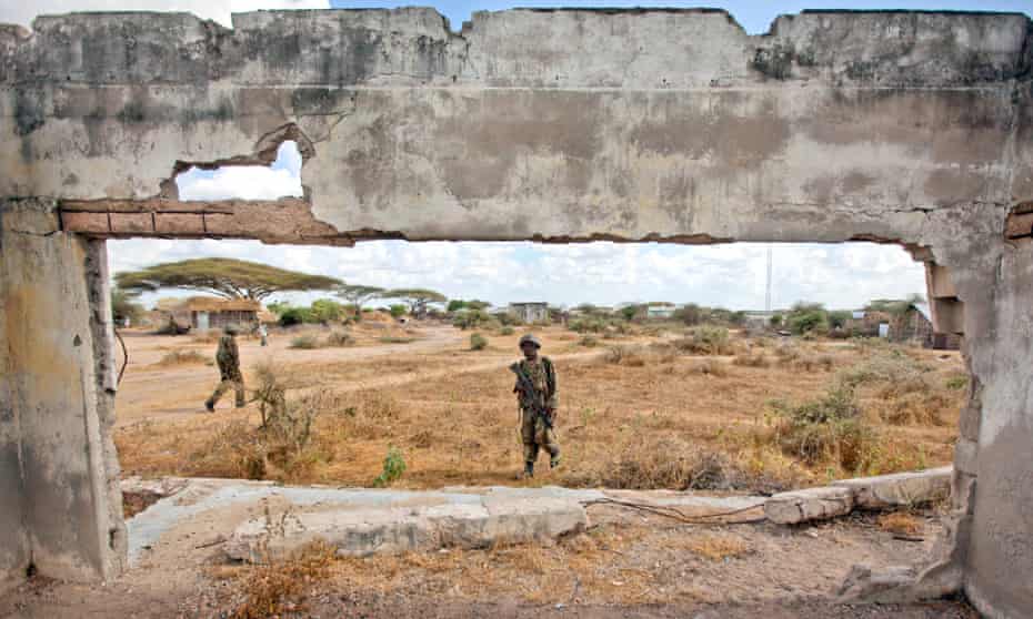 Kenyan army soldiers patrol in Tabda, across the border inside Somalia