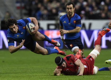 France's centre Remi Lamerat falls to the ground after being tackled.