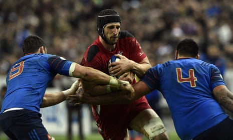 Wales's lock Luke Charteris is stopped by Damien Chouly and Romain Taofifenua.