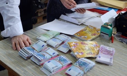 Employees prepare envelopes with banknotes during a secret operation in Saint-Avold, eastern France.