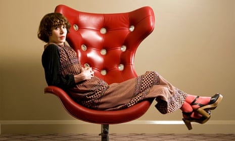 Miranda July leaning back in a chair, hands crossed