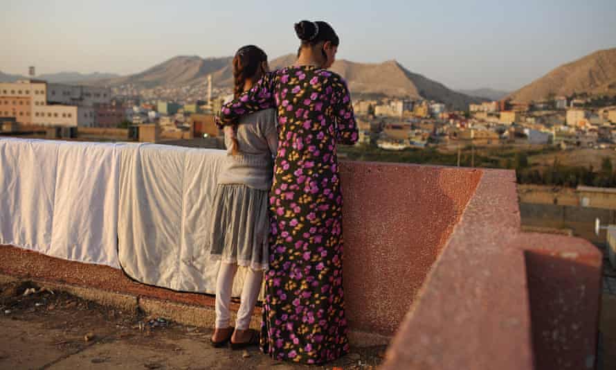 On the run: two Yazidi girls who escaped captivity from Isis militants on the roof of a school in Duhok.