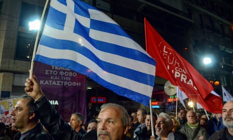Protesters wave flags at a rally during a pre-election rally in Athens. 