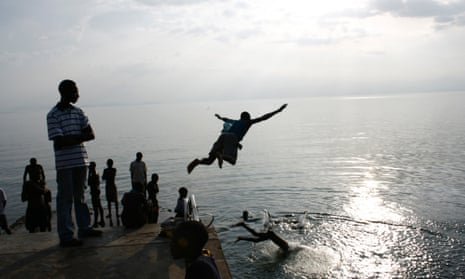 Men dive into the waters of Lake Kivu, Kisegi, Rwanda