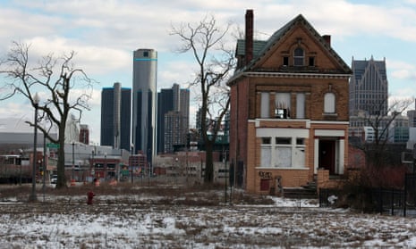 A boarded up house in Brush Park with downtown Detroit behind it