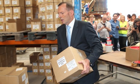 Tony Abbott does some heavy lifting at a timber factory in Melbourne