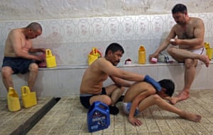 Kabul, Afghanistan A man gives his son a massage as they take a bath at a public bath, or hamam. The tradition public baths are mostly found in larger cities and used by ordinary citizens many of whom have had hot water facilities damaged during its decade-long war