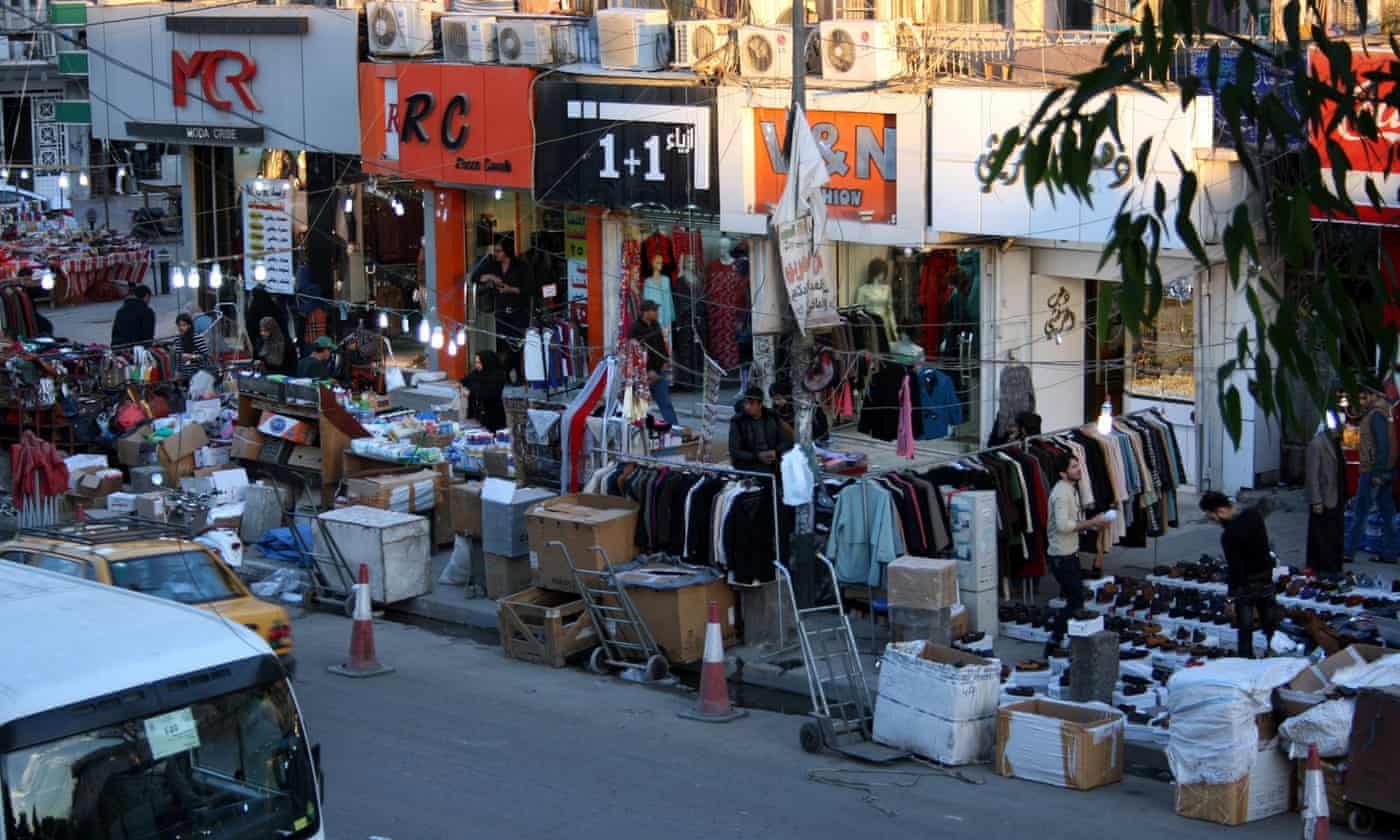 Baghdad hit by suicide bombings as government due to end curfew