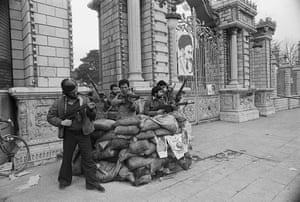 Pro-Khomeini forces man a bunker in front of Iran's parliament building, expecting an attack from the Shah's elite troops