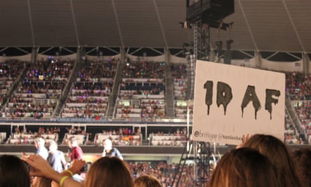A One Direction fan holds up her cheeky sign.