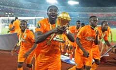 Ivory Coast's Kolo Touré raises the trophy after the final.