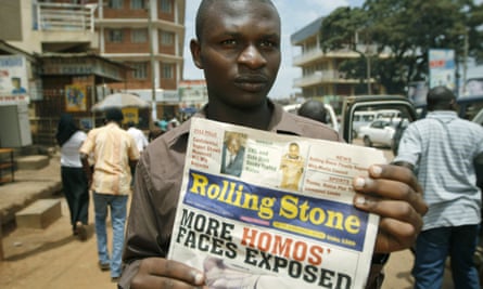 A photo from 2010 shows the managing editor of The Rolling Stone newspaper, which has no relation to the US magazine, Giles Muhame, holding an issue of his publication in Kampala. The issue published the names and photos of 14 men it identified as gay.