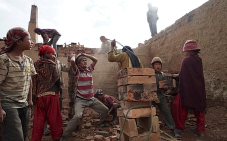 Children and adults offload baked bricks from a brick factory in Panchkhal, Dhading district, Nepal. An estimated 28,000 children work in the brick factories in Nepal.