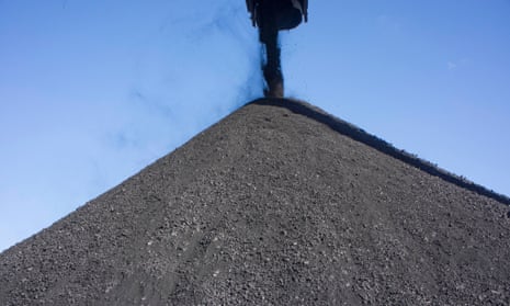 Coal falls from an elevator onto a storage pile