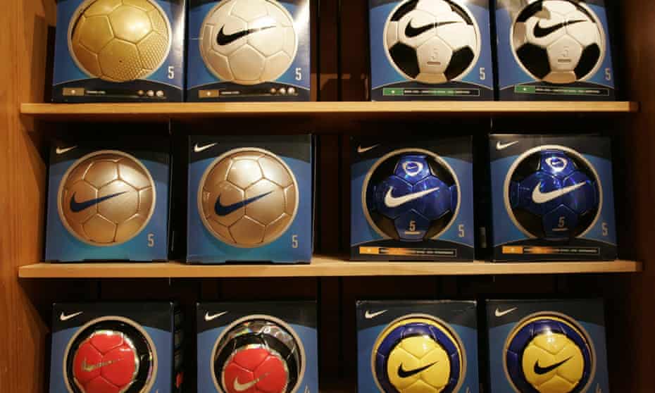 Nike brand soccer balls are on display at a Nike store. A 1996 story exposing child labor in the manufacture of soccer balls put Nike on the defensive.