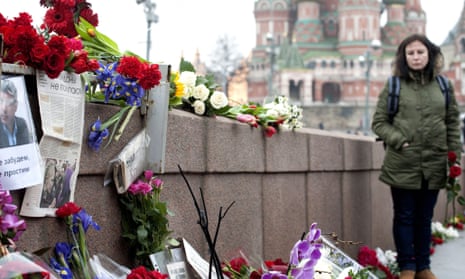 People lay flowers at the place where Boris Nemtsov was killed in Moscow.