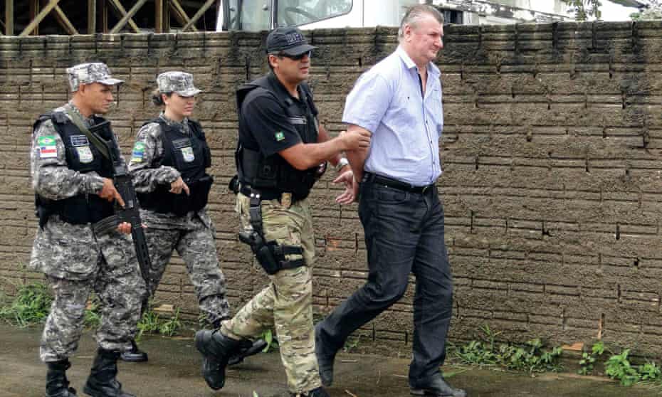Ezequiel Antônio Castanha (right), who is accused of illegally destroying tens of thousands of square kilometres of Amazon forest, is arrested by federal police officers in Novo Progresso in the northern state of Para, Brazil.