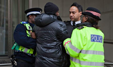 A young black male is arrested by police.