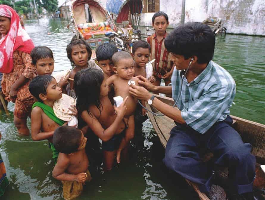 A doctor checks children in Dhaka, Bangladesh