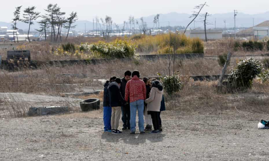 Young people in Miyagi prefecture, northern Japan, offer silent prayers for victims of the 2011 disaster.