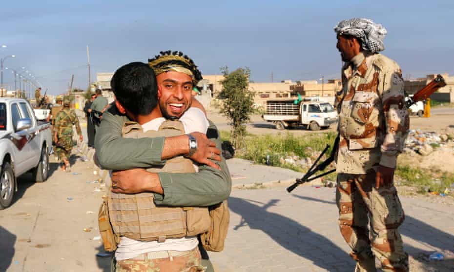 Residents welcome a relative who is part of Hashd al-Shaabi in the town of al-Alam, where Iraqi troops drove out Isis on Tuesday.