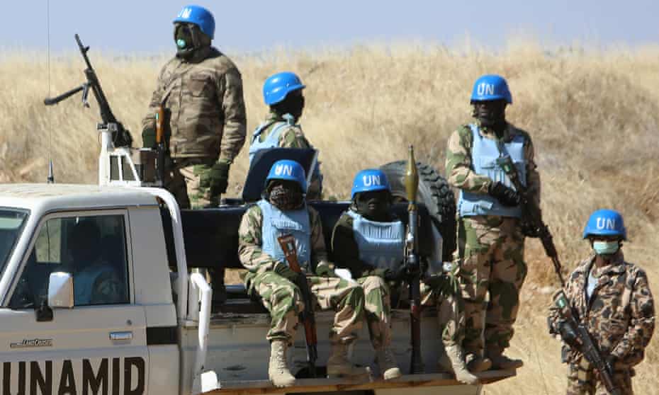 Members of the UN-African Union mission in Darfur (UNAMID) patrol the area near the city of Nyala in Sudan's Darfur on January 12, 2015. Qatar's deputy premier Ahmed bin Abdullah al-Mahmud is on a visit to the war-torn western region of Sudan for the ninth meeting of the committee monitoring the implementation of the Doha Document for Peace Darfur (DDPD).