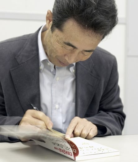 Akira Haraguchi signs his book