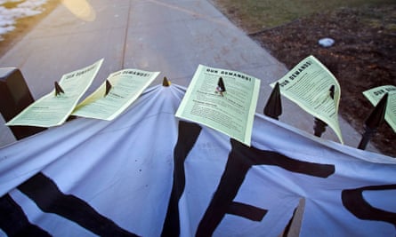 Demands for Governor Scott Walker are seen affixed to the gate by protesters rallying in Madison, Wisconsin.