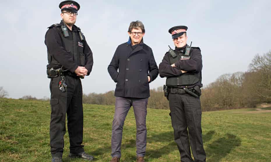 Alan Rusbridger with two police officers