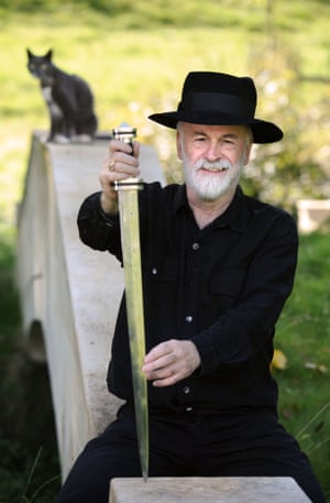 Terry Pratchett at home in Wiltshire with the sword that he forged from his own iron ore