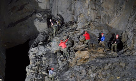 A group makes its way along one of the via ferrata sections (hooking on to cables)