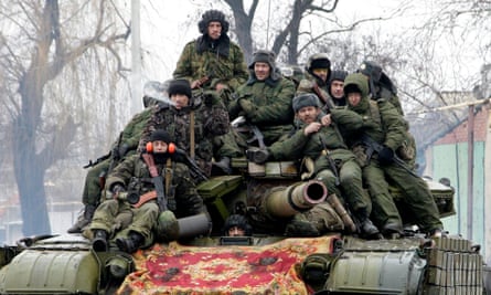 Members of self-proclaimed Donetsk People's Republic drive a tank on the outskirts of Donetsk in January.