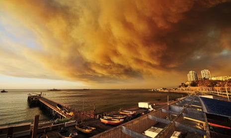 Smoke billows from the forest around Valparaiso as a fire threatens to reach the city's port.
