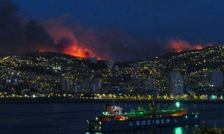 Flames light up the night sky above Valparaiso.