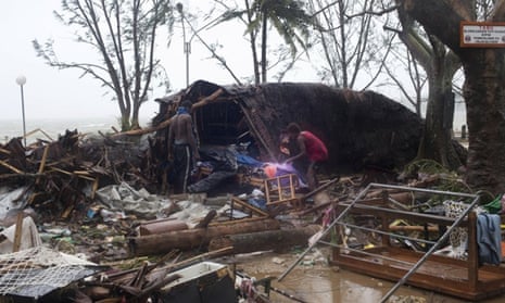 In this image provided by UNICEF Pacific people scour through debris damaged and flung around in Port Vila, Vanuatu, Saturday, March 14, 2015, in the aftermath of Cyclone Pam. Winds from the extremely powerful cyclone that blew through the Pacific's Vanuatu archipelago are beginning to subside, revealing widespread destruction. (AP Photo/UNICEF Pacific, Humans of Vanuatu) EDITORIAL USE ONLY, NO SALES