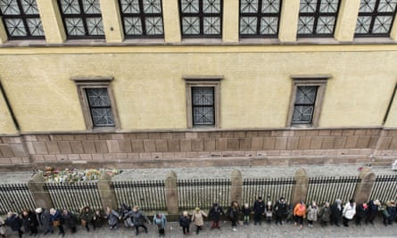 People hold hands in a ring of peace around the Jewish synagogue in Copenhagen to symbolise unity in the fight against terrorism.