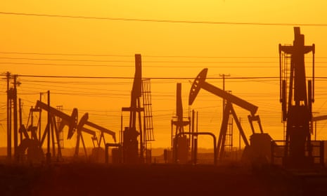 Pump jacks are seen at dawn in an oil field near Lost Hills, California.