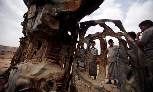 Boys gather near the wreckage of car destroyed last year by a US drone air strike targeting suspected al Qaeda militants in the southeastern Yemeni province of Shabwa in 2013.