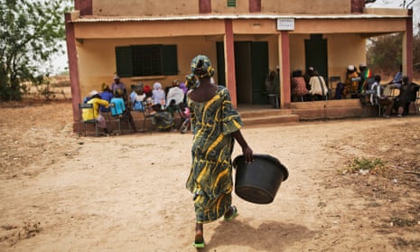 Nurse Vinima Baya, 29, retrieves a big tub that women in labour use to bring clean water to the clinic when they are giving birth, at the community health centre (pictured) in the village of Diatoula, 15km outside of Bamako, Mali.