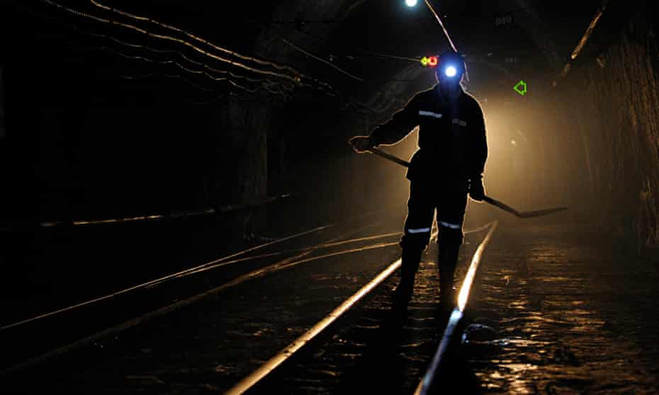 A miner walks along tracks used for transporting coal in Xiaoyi, Shanxi province, China.