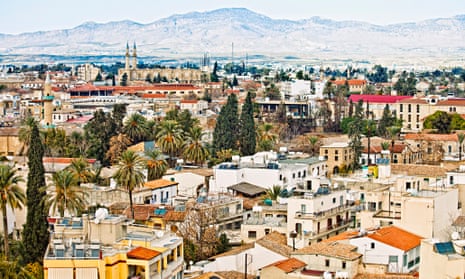Rooftops and trees of Nicosia, Cyprus, with mountains behind