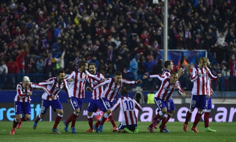 Atletico Madrid's players celebrate after Stephan Kiessling ballooned his penalty over the bar.  The Spanish side are in the Quarter-Finals.