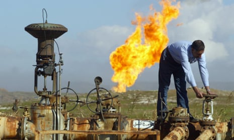 A worker turns a valve at the Shirawa oilfield, where oil was first pumped in Iraq in 1927, outside the northern city of Kirkuk.