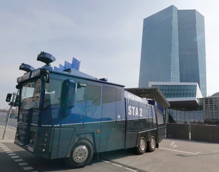 A police vehicle is parked near the European Central Bank building