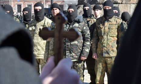 A priest blesses fighters of the Ukrainian Donbass volunteer battalion 
